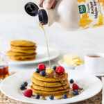 Pumpkin Pancakes with Maple syrup being poured on them