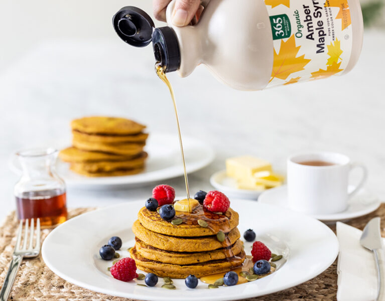 Pumpkin Pancakes with Maple syrup being poured on them