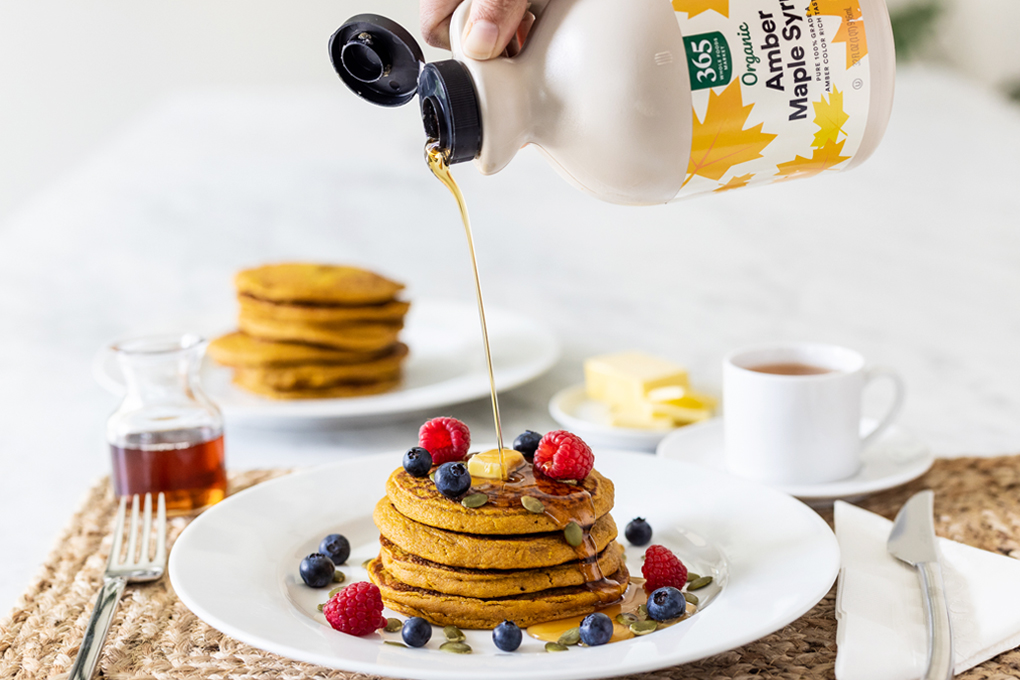 Pumpkin Pancakes with Maple syrup being poured on them